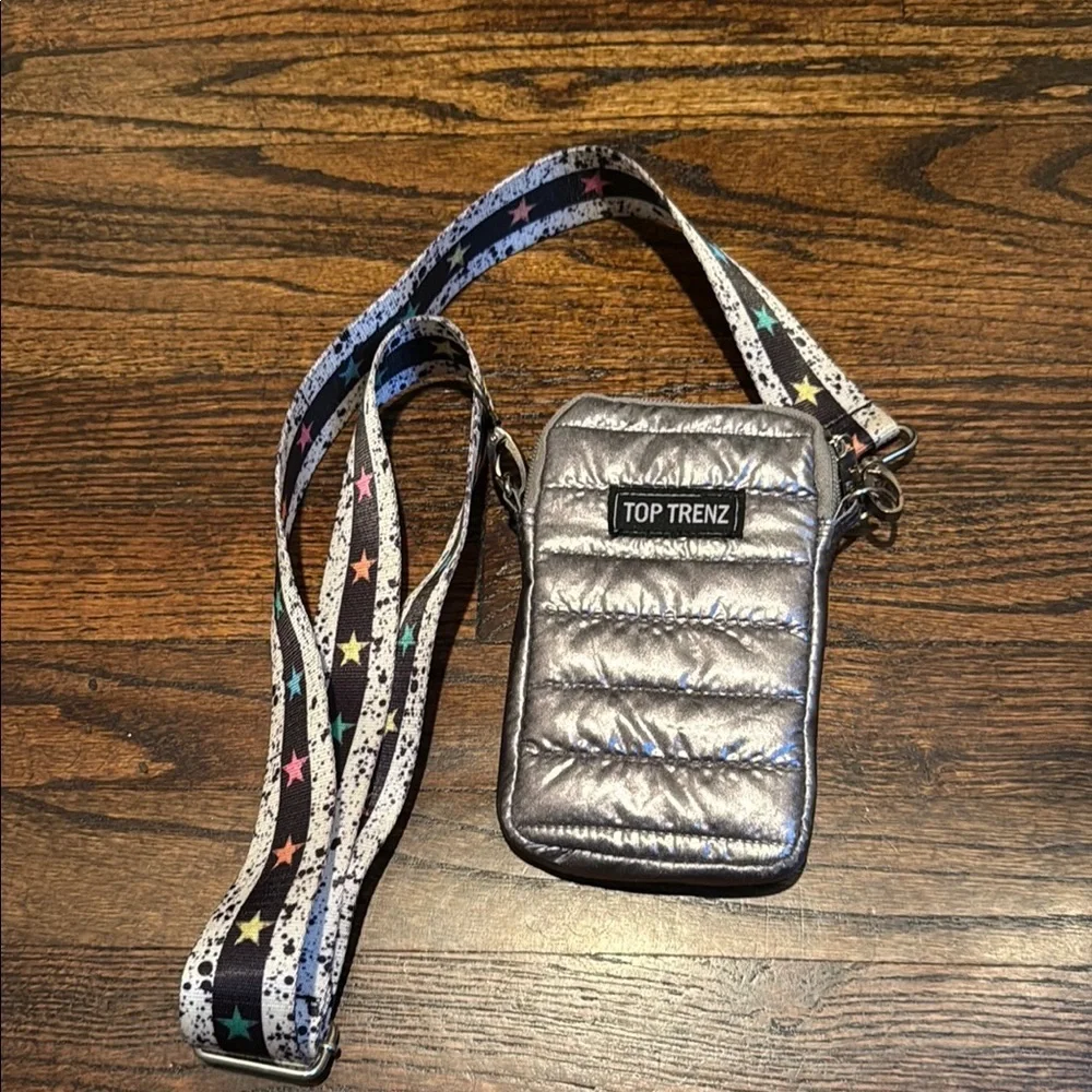 This is a Top Trenz Puffer Cell Bag with an original striped tie-dye strap
